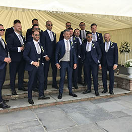 a group of groomsmen posing